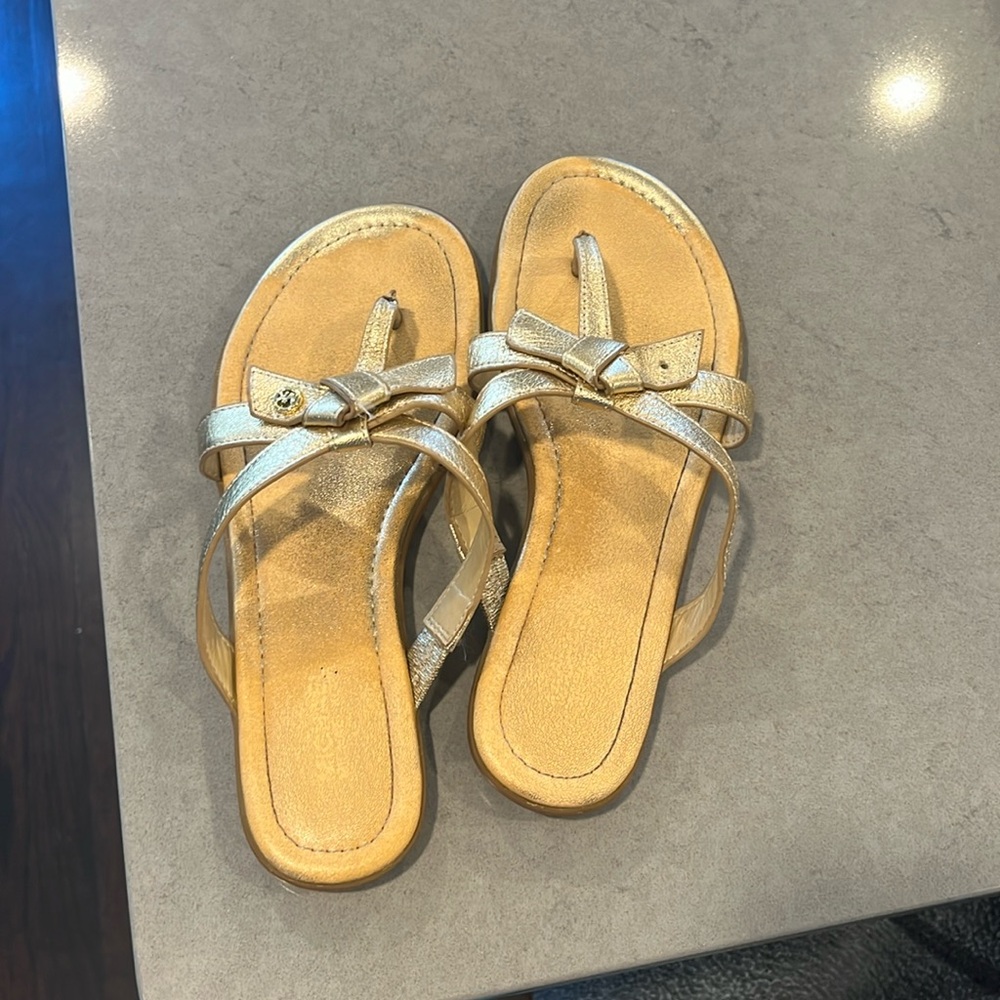Girls gold flats.